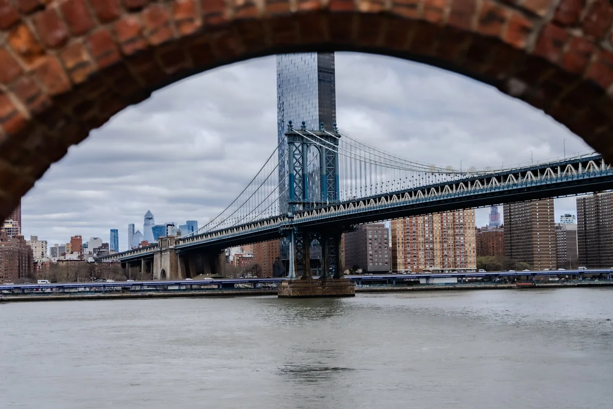 Manhattan Bridge through brick arch