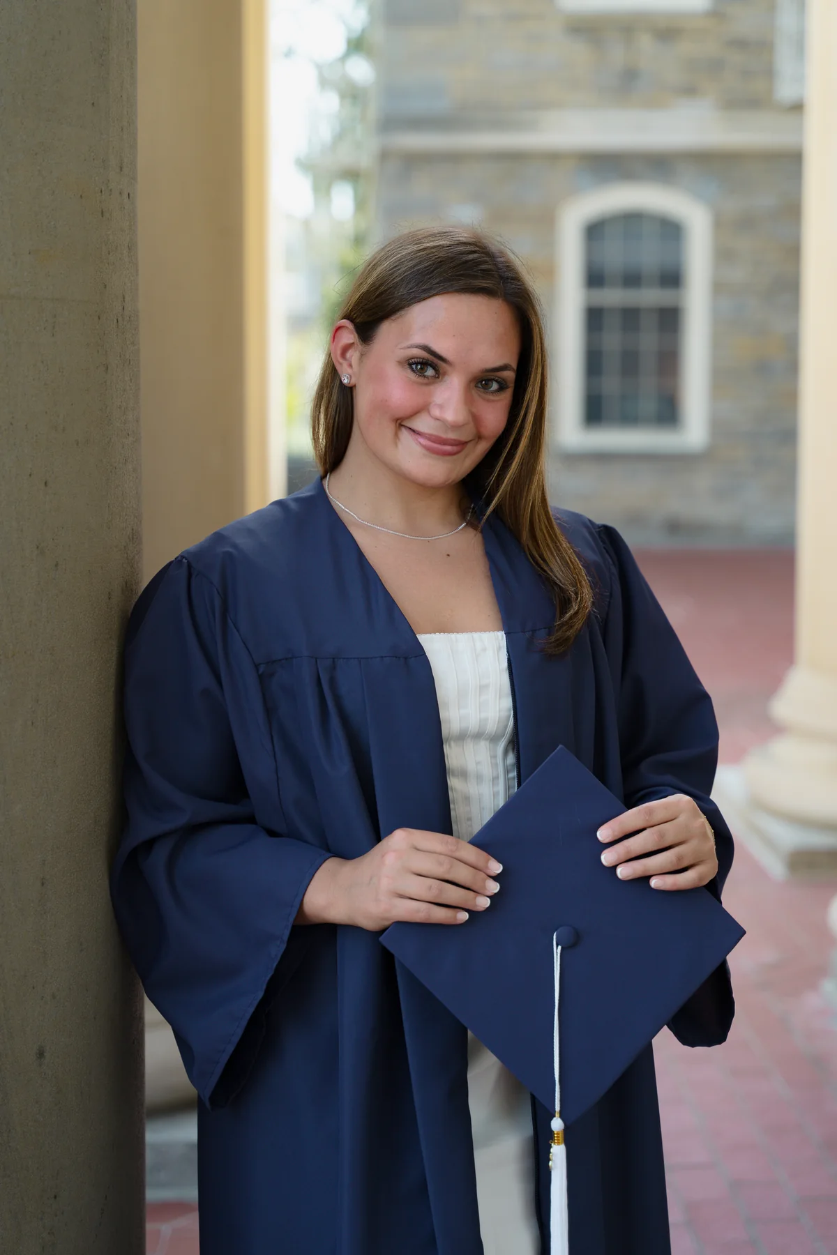 Graduate beside a stone column